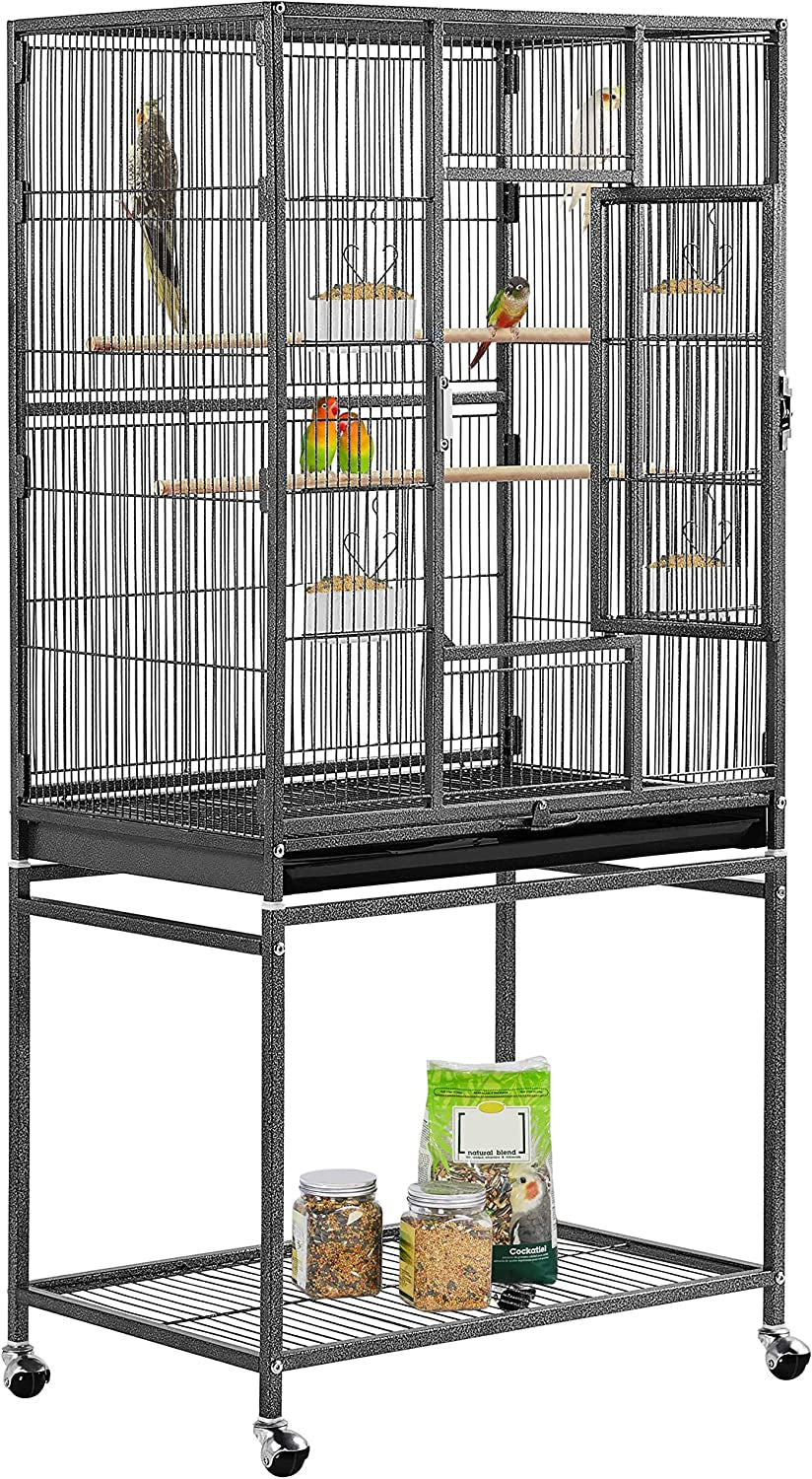 Bird cage with perches and a stand containing bird food on a white background