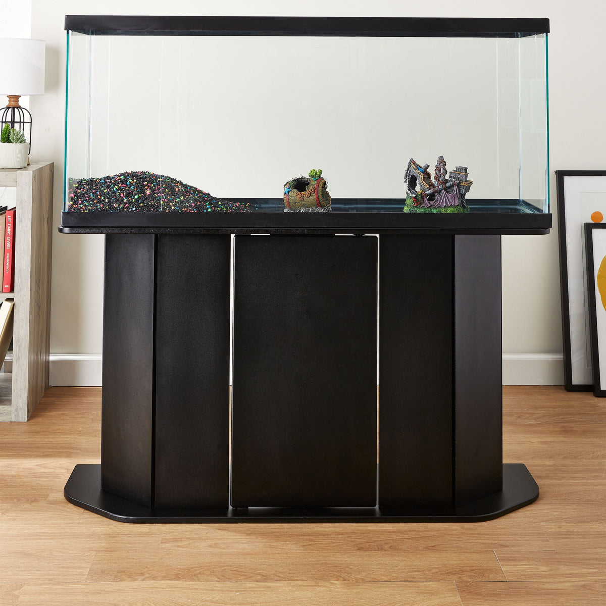 Fish tank with black stand on a wooden floor