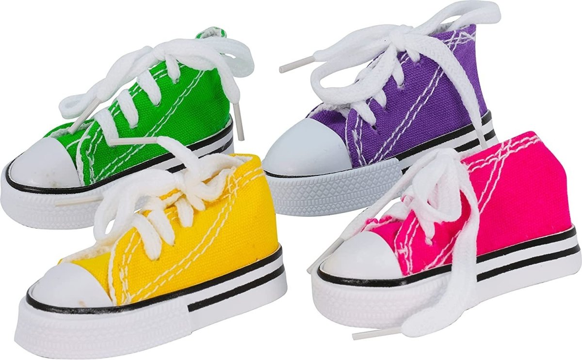 Four colorful sneakers in green, yellow, purple, and pink on a white background