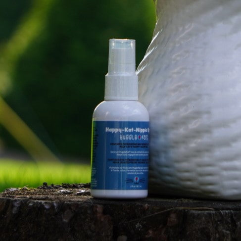 Spray bottle with blue label on a wooden surface with a blurred background