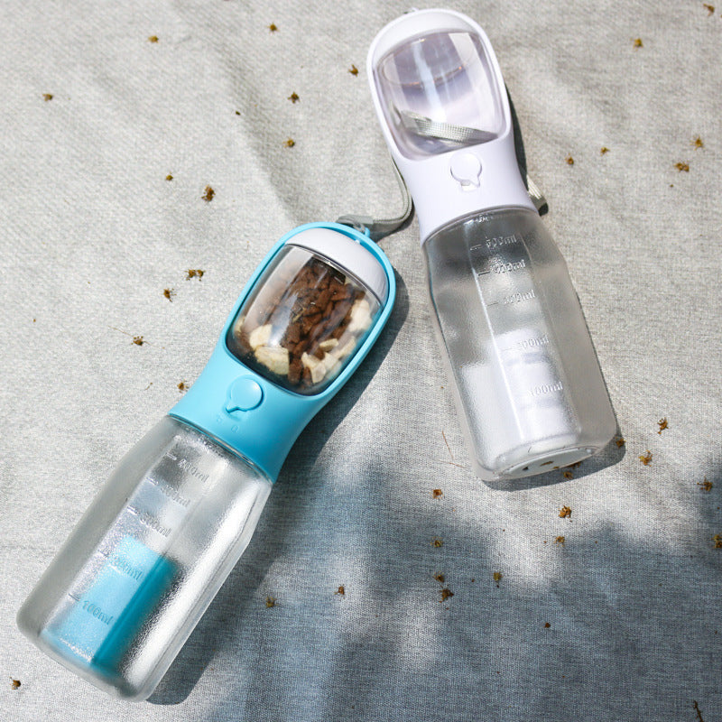 Pet water bottle and food dispenser on a textured surface