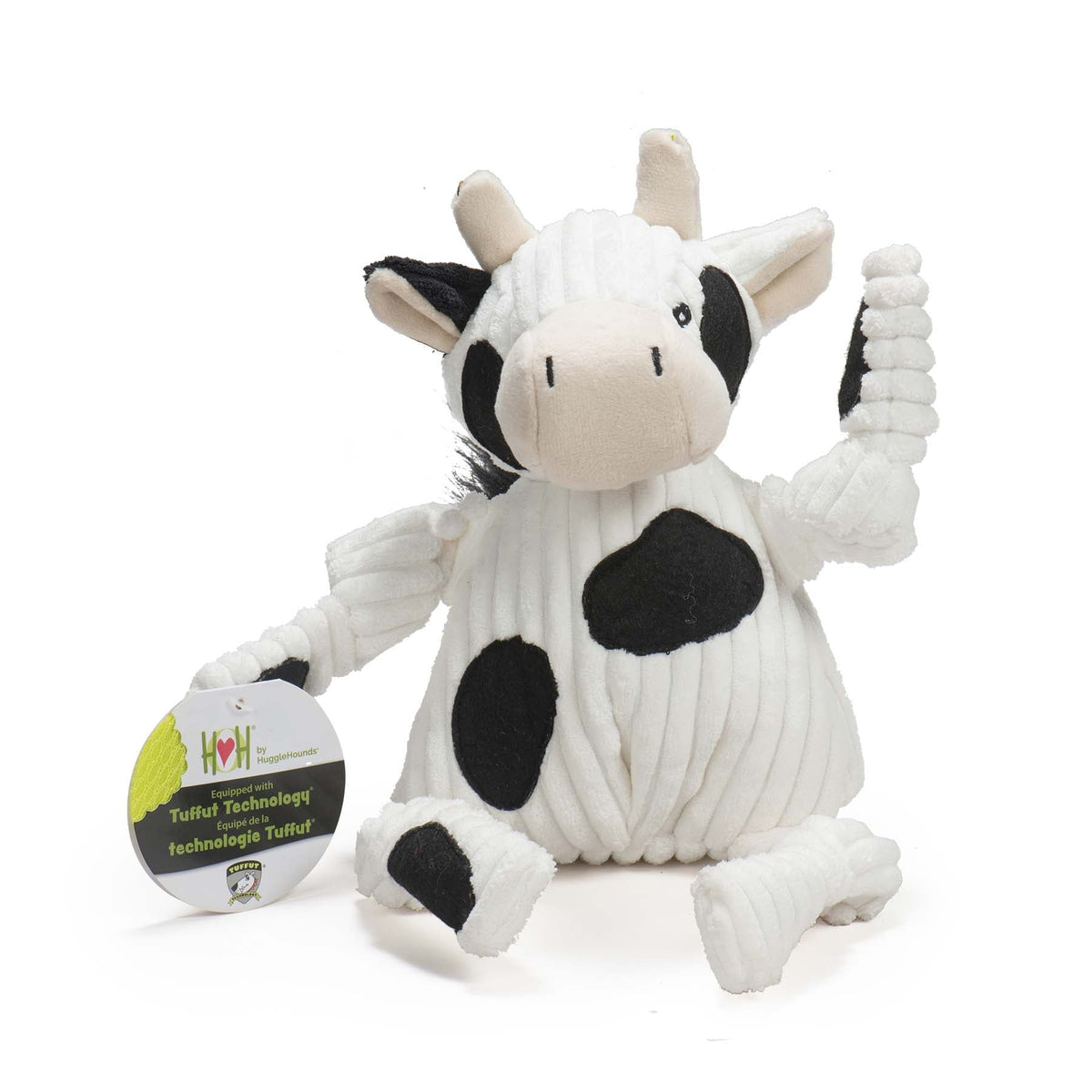 Plush cow toy with a tag on a white background