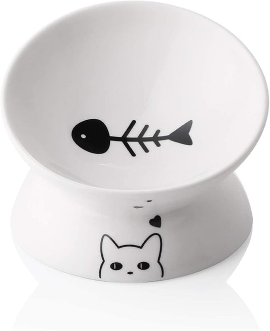 White ceramic dish with black fish bone and cat face design on a white background