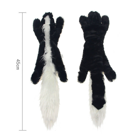 Black and white plush toy resembling skunk feet with measurements on a white background