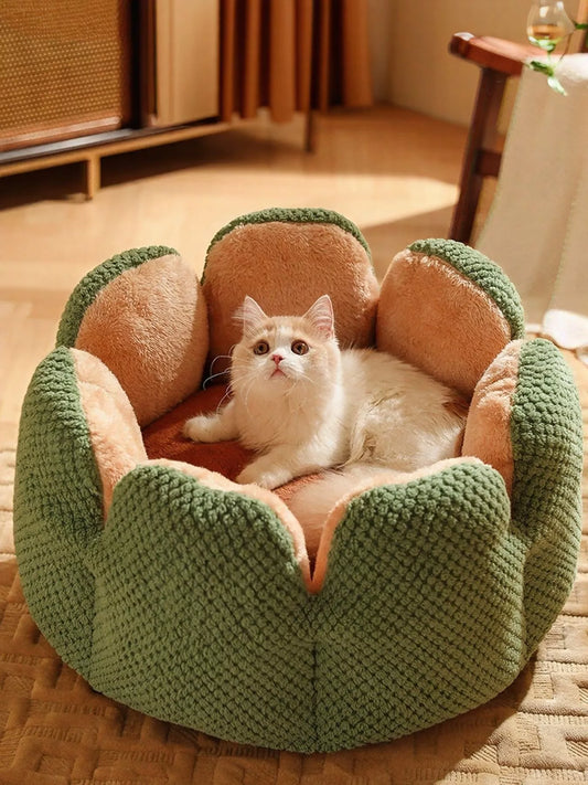 Cat lying on a green and brown pet bed in a cozy room.
