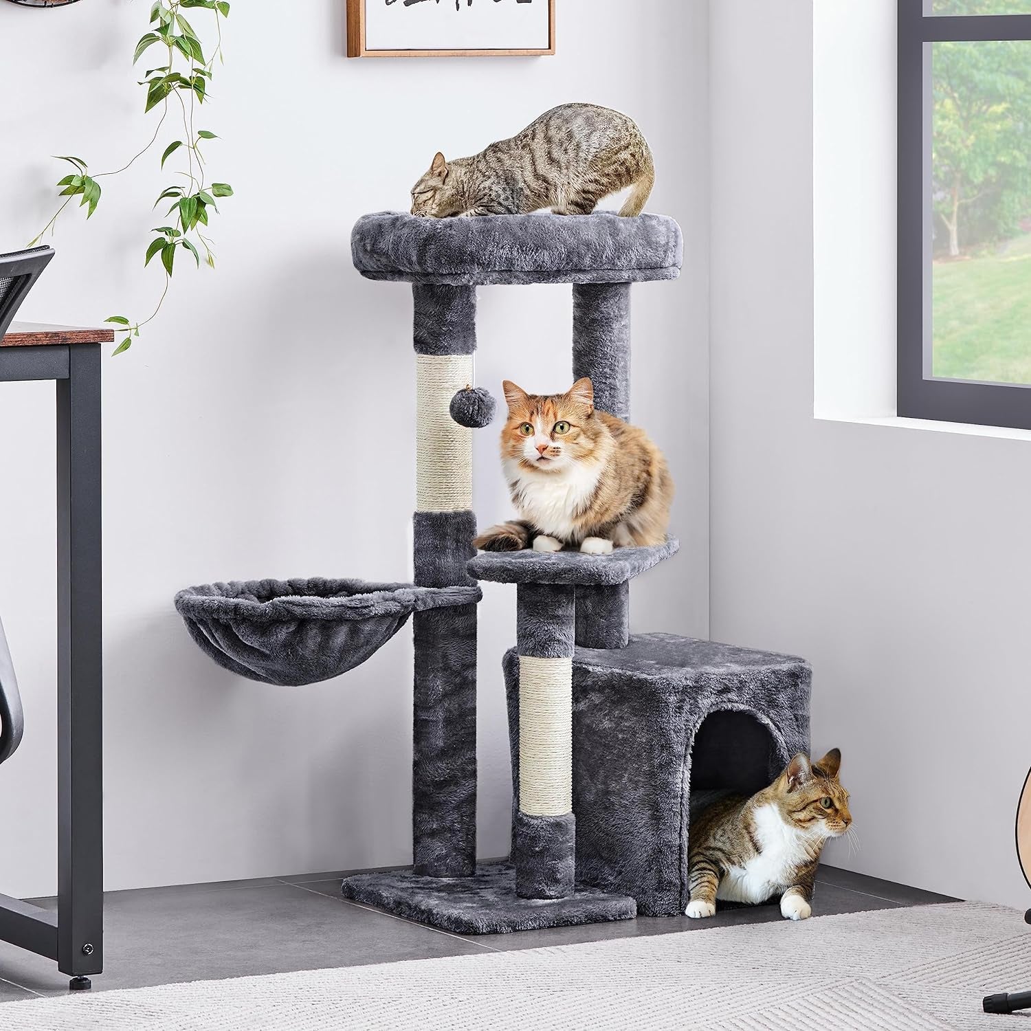 Cat tree with cats on a gray carpeted floor