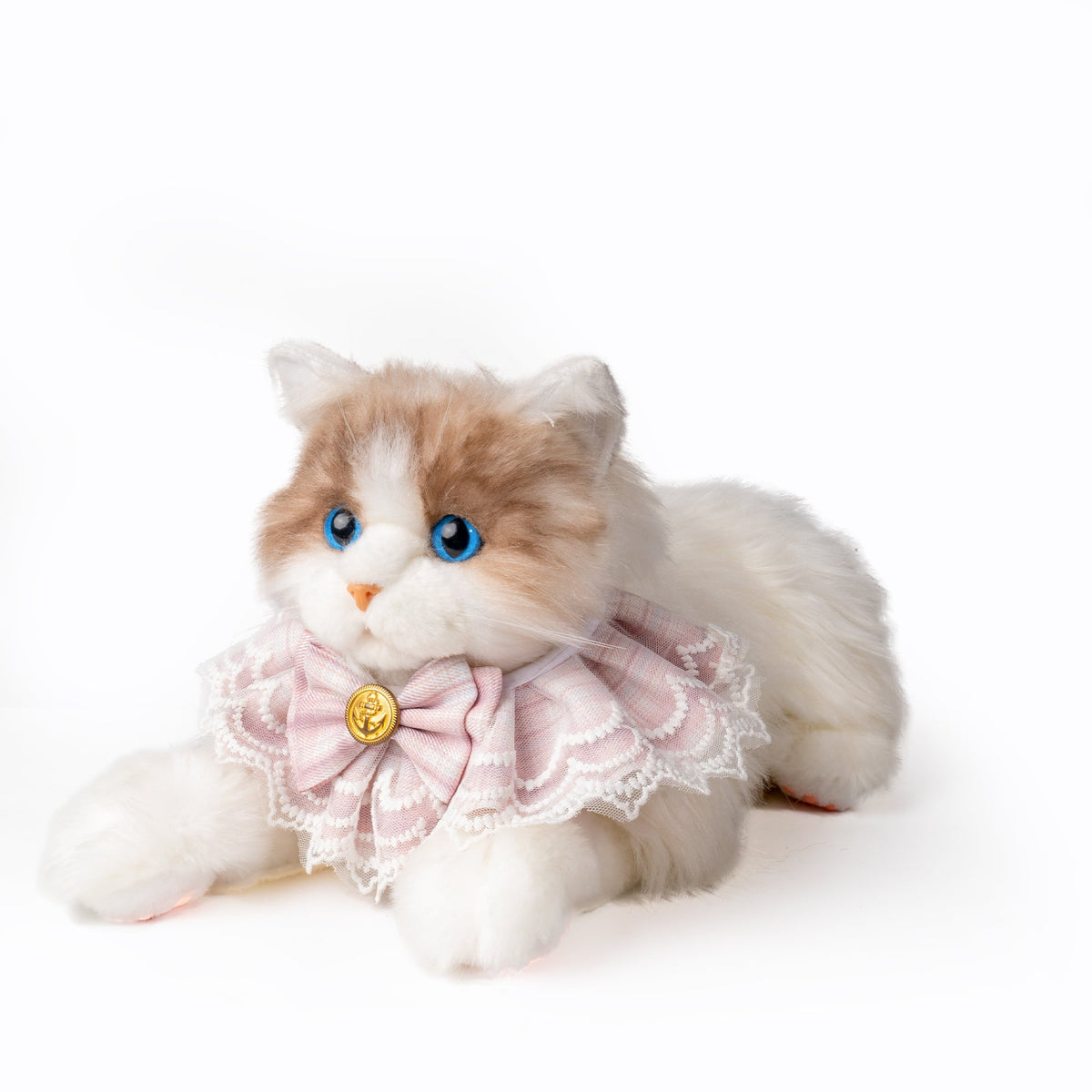 Stuffed cat toy with a pink bow and gold button on a white background