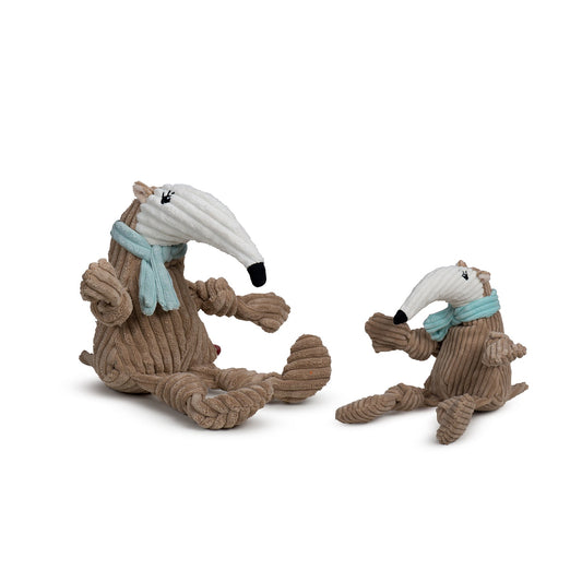 Two plush toys resembling anteaters with scarves on a white background