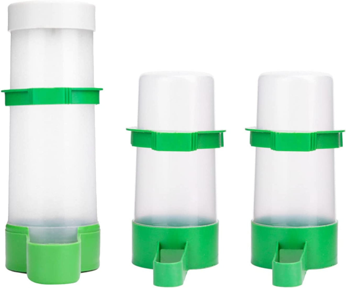 Three green and white plastic feeders on a white background
