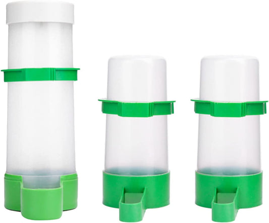 Three green and white plastic feeders on a white background