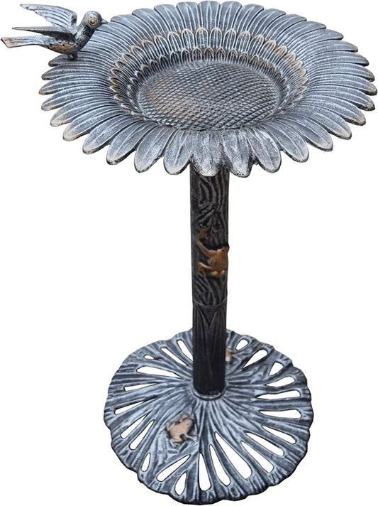 Decorative metal bird bath with intricate design on a white background