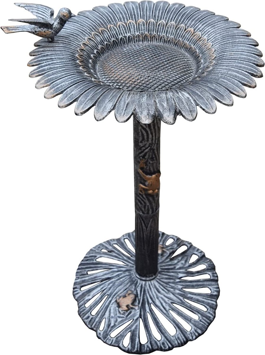 Decorative metal bird bath with intricate design on a white background