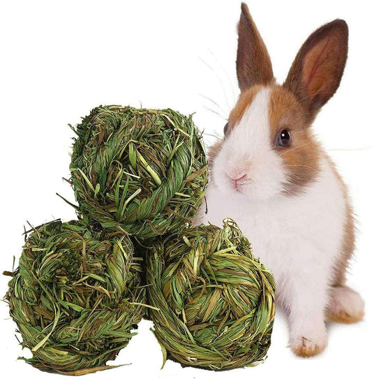 Three green grass balls with a rabbit on a white background