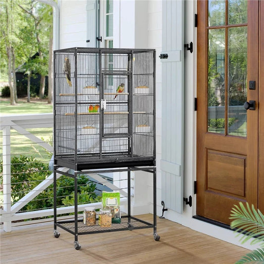 Bird cage on wheels in a home setting with a wooden door and garden view.