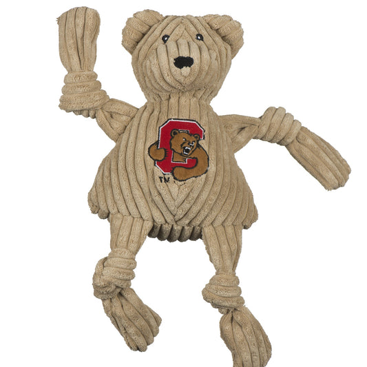 Beige knitted bear-shaped toy with a logo on a white background