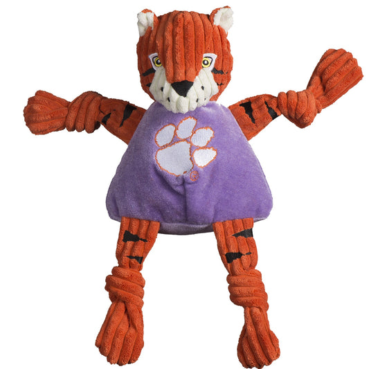 Plush tiger toy with a purple shirt featuring a paw print on a white background
