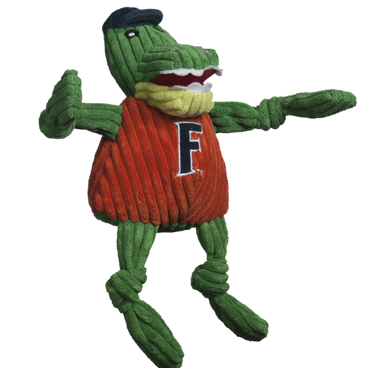 Green plush toy with red sweater and 'F' logo on a white background