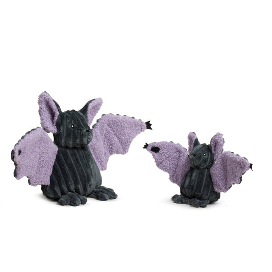 Two plush dragon toys with purple wings on a white background