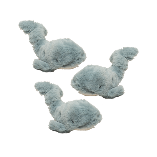 Set of three blue whale-shaped slippers on a white background