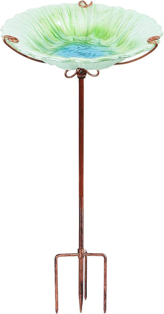 Glass bird bath with copper stand on a white background