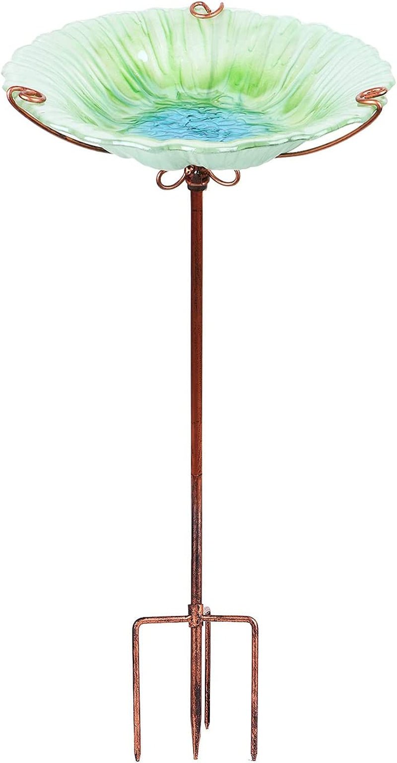 Glass bird bath with copper stand on a white background