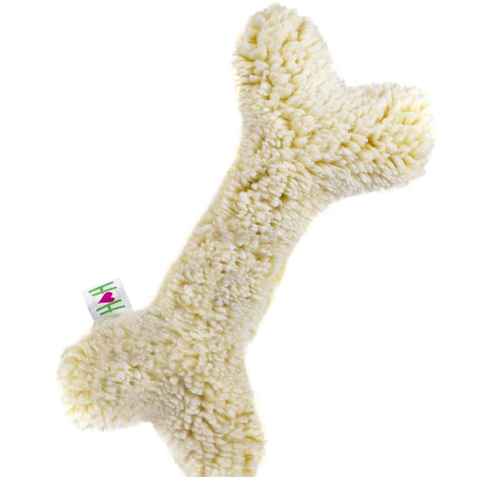 Fluffy bone-shaped toy with a tag on a white background