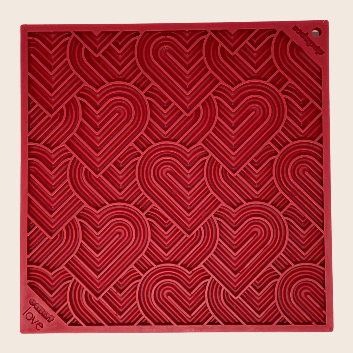 Red textured square with heart patterns on a beige background