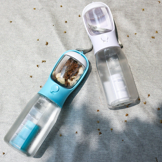 Pet water bottle and food dispenser on a textured surface