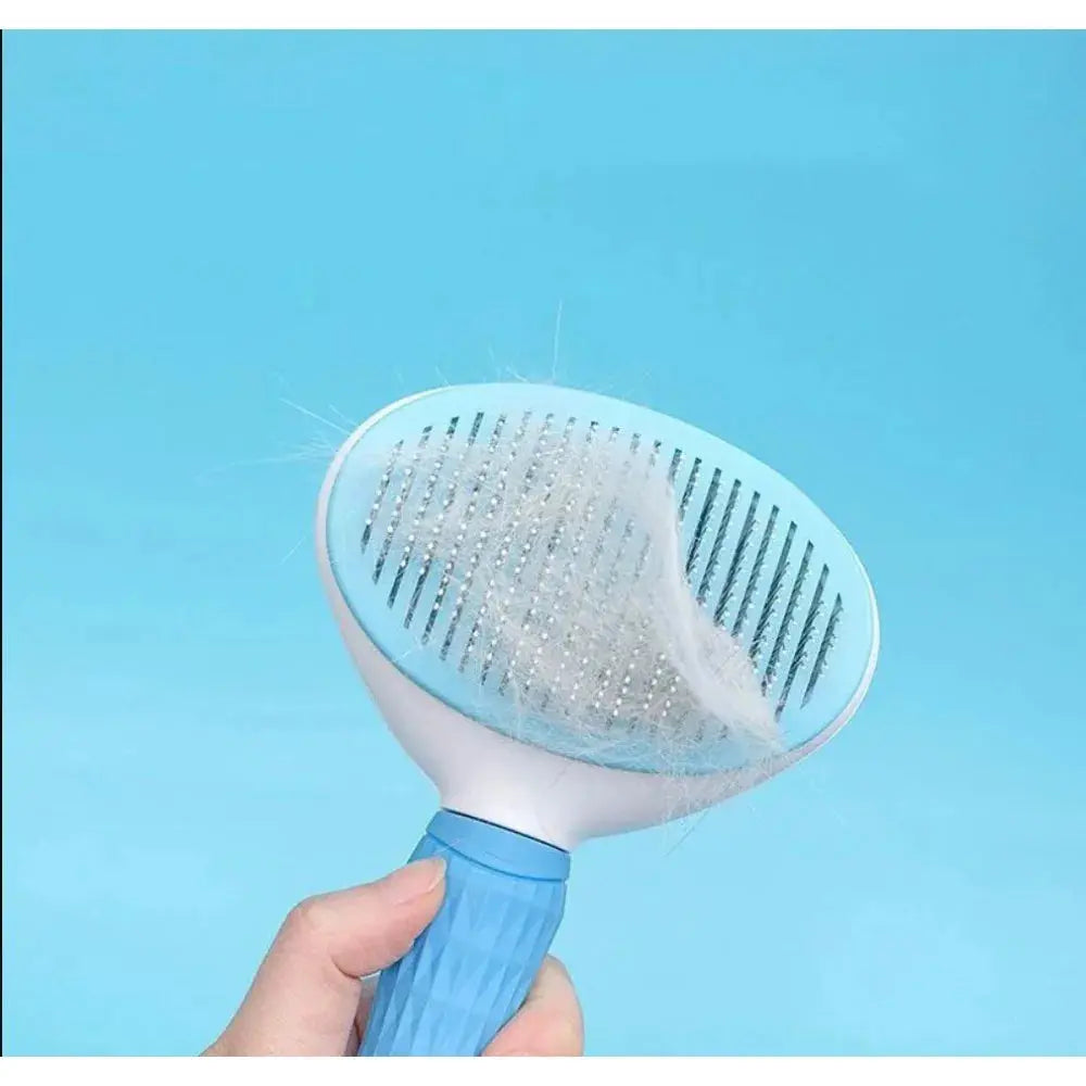 Pet grooming brush with collected fur against a blue background