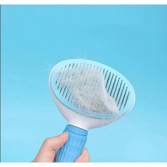 Pet grooming brush with collected fur against a blue background