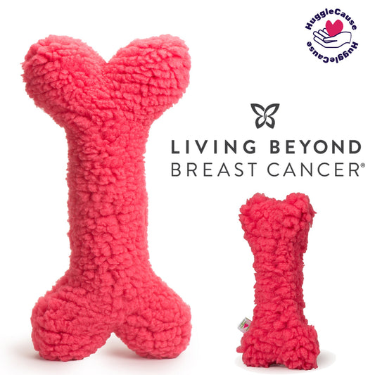 Pink textured bone-shaped pillow with 'Living Beyond Breast Cancer' text and HugglePouch logo on a white background.