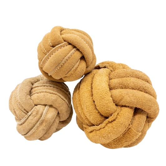 Three beige knotted balls on a white background
