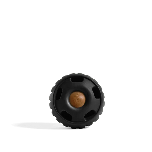 Black textured ball with a brown center on a white background