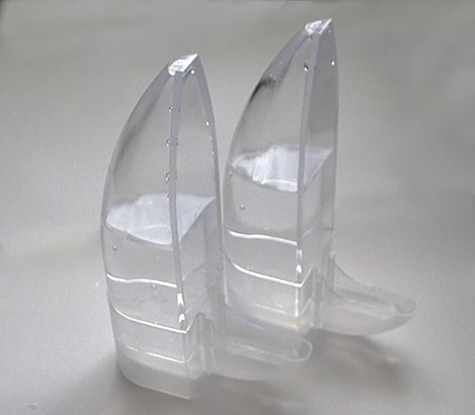 Clear plastic boot-shaped objects on a gray background
