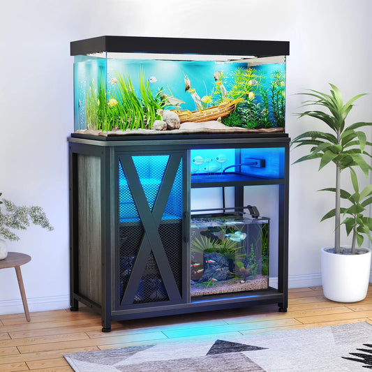 Fish tank with stand and aquatic plants on a wooden floor.