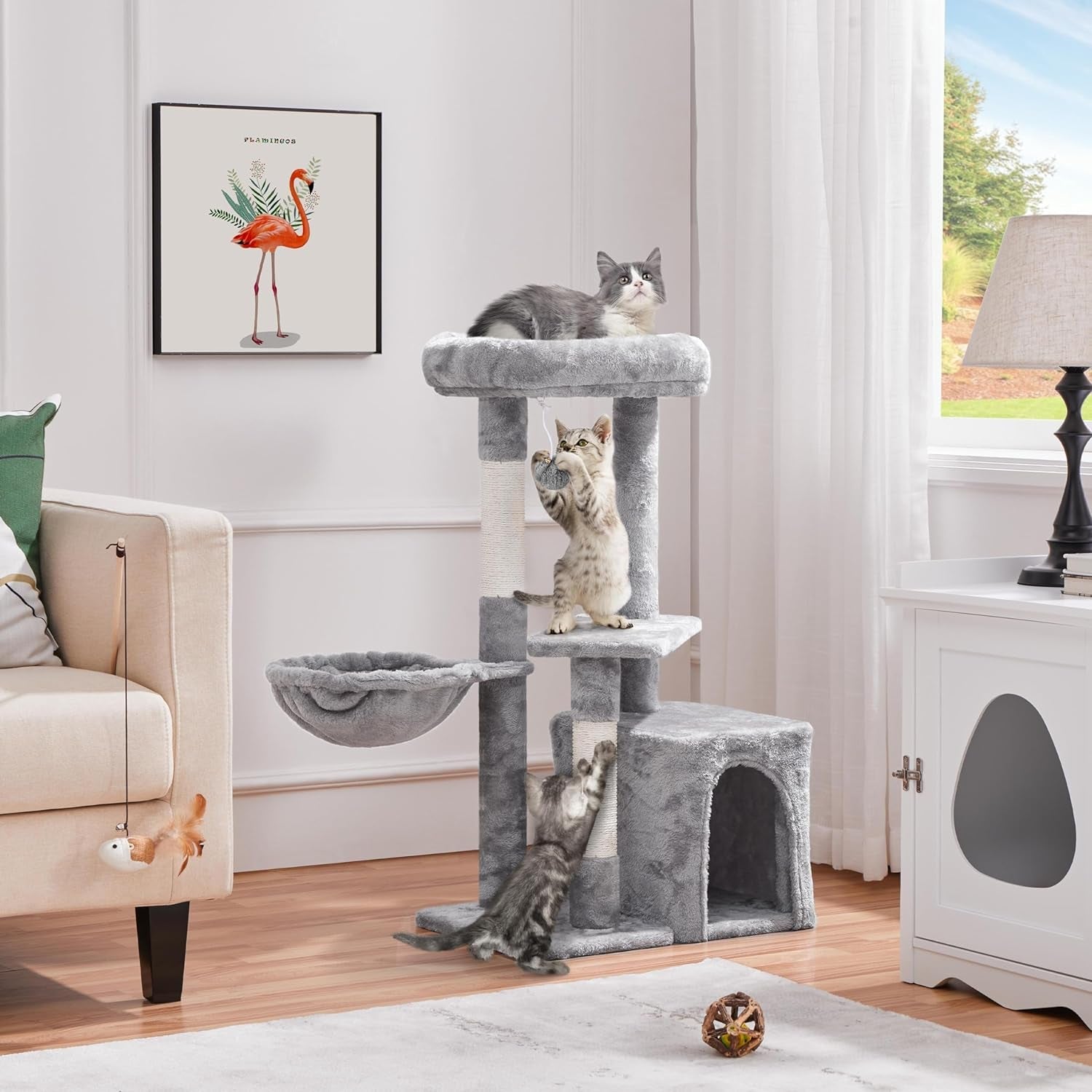 Gray cat tree with cats in a living room setting