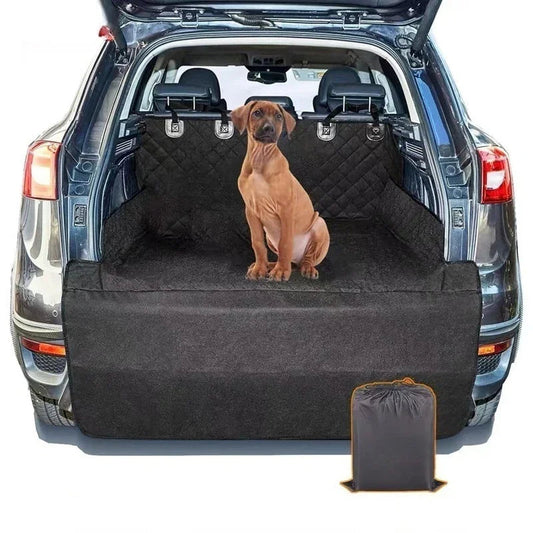 Dog sitting on a black pet bench cover in the back of a car