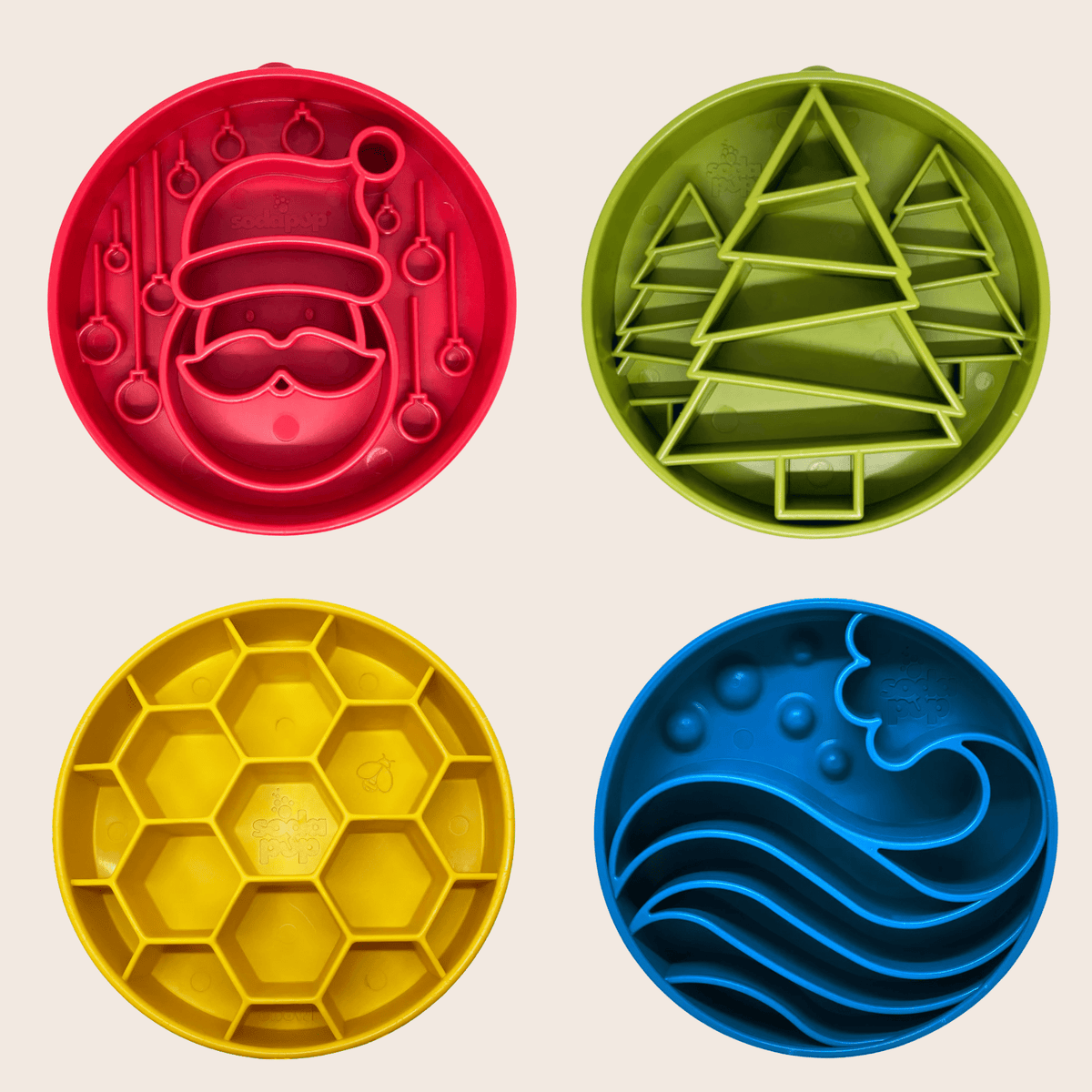Four colorful cookie cutters with different designs on a beige background