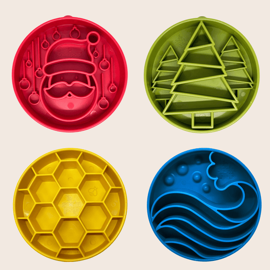 Four colorful cookie cutters with different designs on a beige background