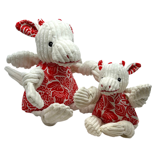 Two plush toys with white bodies and red patterned dresses on a white background