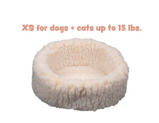 Small fluffy pet bed for dogs and cats up to 15 lbs on a white background
